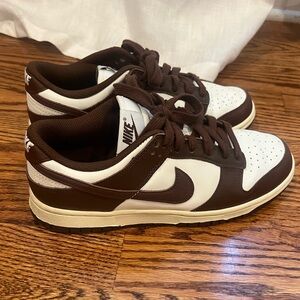 Woman’s brown Nike dunks